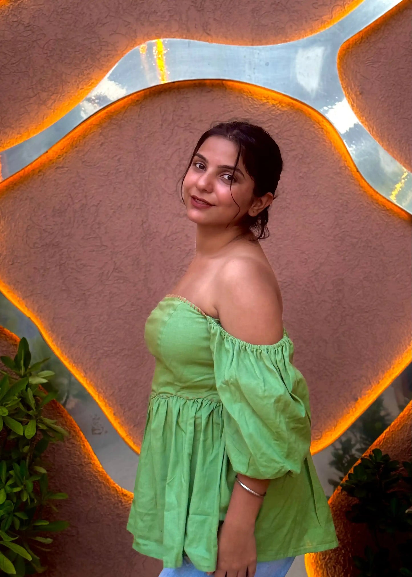 Green off-shoulder puff sleeve top with flared waist, modern feminine fit, soft fabric for women’s wear by An-Attire.