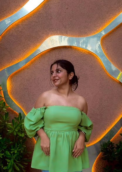 Green off-shoulder puff sleeve top with flared waist, modern feminine fit, soft fabric for women’s wear by An-Attire.