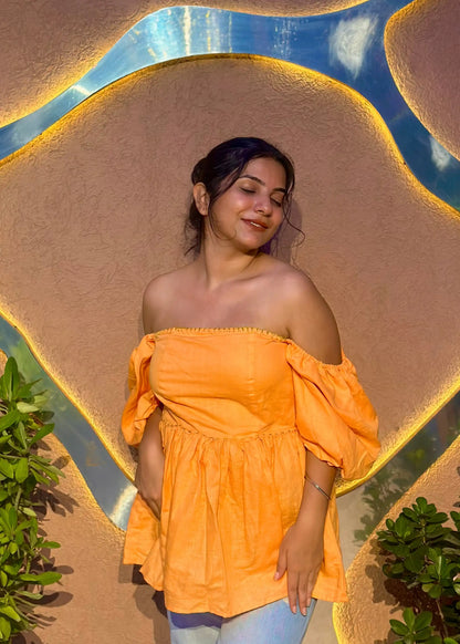 Yellow-orange off-shoulder puff sleeve top with flared waist, relaxed fit, and soft fabric for women by An-Attire.