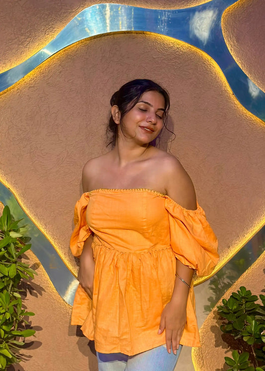 Yellow-orange off-shoulder puff sleeve top with flared waist, relaxed fit, and soft fabric for women by An-Attire.
