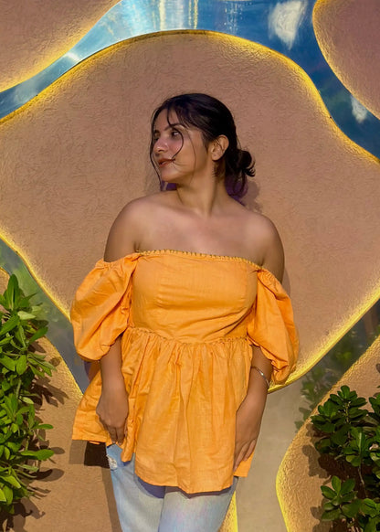 Yellow-orange off-shoulder puff sleeve top with flared waist, relaxed fit, and soft fabric for women by An-Attire.